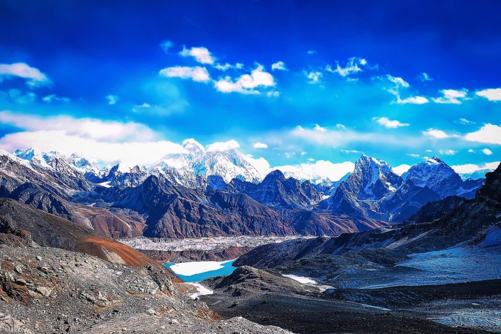 View of Everest Base Camp with rugged terrain and mountain backdrop, featured in the Everest Designer Trek high-altitude fashion adventure.