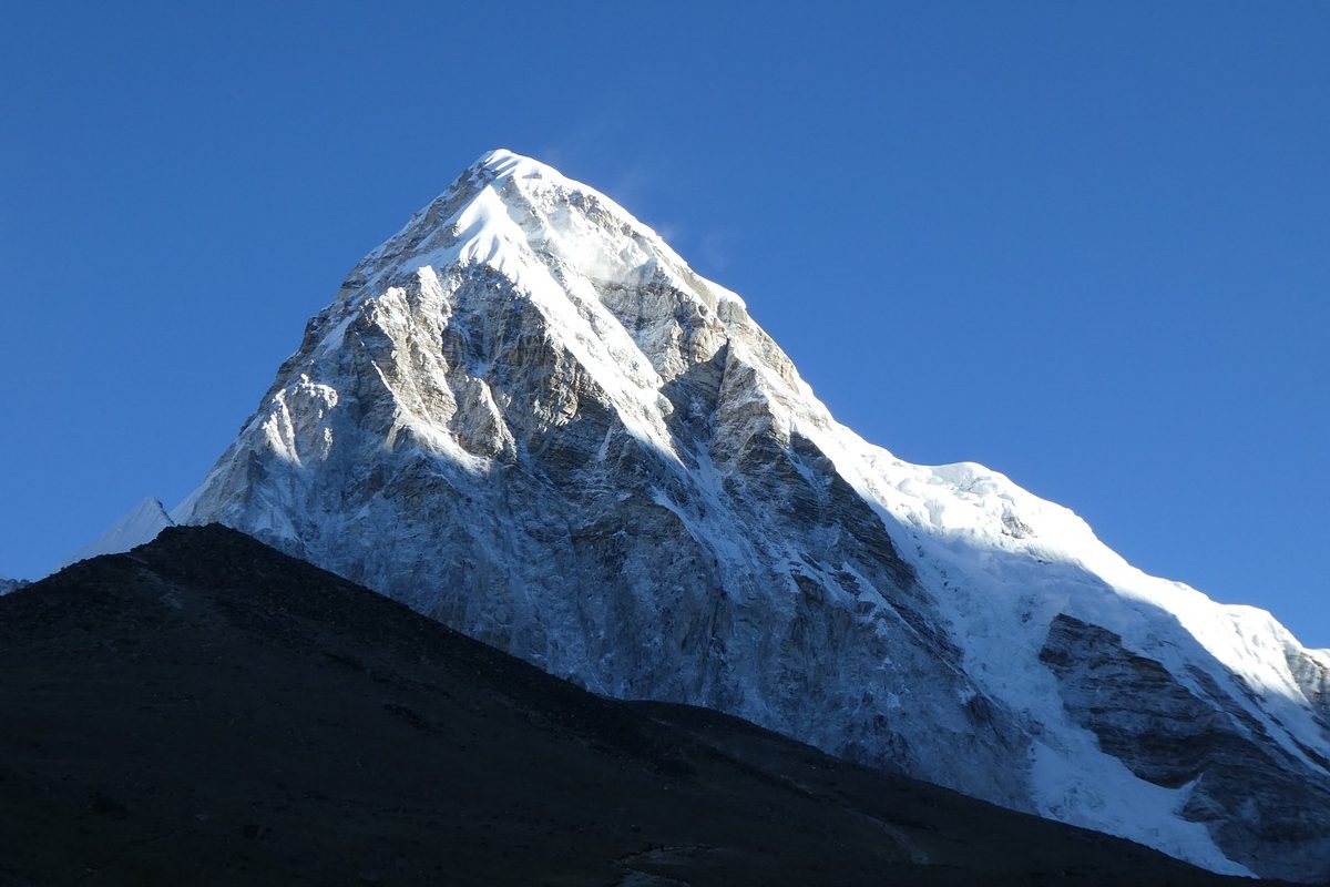 Trekkers approaching Everest Base Camp with majestic mountain views, ideal for influencer storytelling and cinematic content capture.