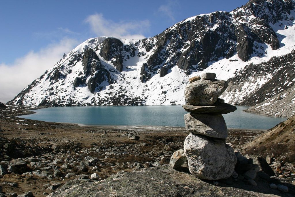 Serene turquoise lake surrounded by rugged Himalayan peaks near Gokyo, Nepal