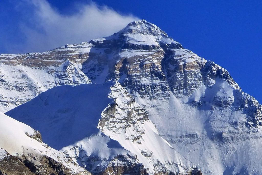 Stunning snow-covered Himalayan peaks under a clear blue sky during Everest Base Camp trek.